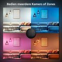 Een woonkamer in vier verschillende sferen, bediend met de Philips Hue Tap dial switch. Boven 2x wit, boven rechts 2x blauw, beneden links 2x roze, beneden rechts 2x oranje.