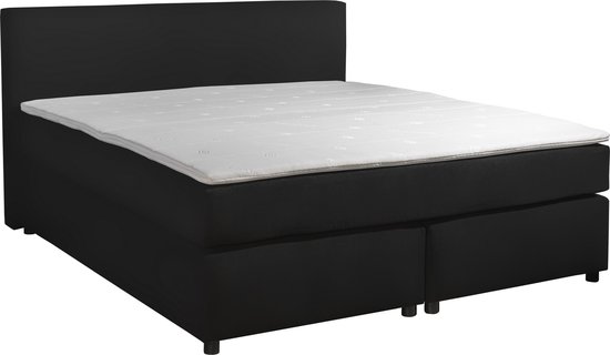 Zwarte boxspring met hoofdbord, wit matras en twee opbergvakken aan de voorzijde.