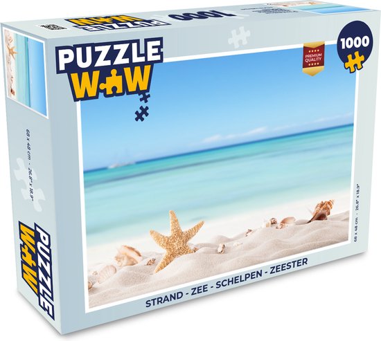 Boîte d'un puzzle de 1000 pièces montrant un paysage de plage, une étoile de mer, des coquillages et le texte 'STRAND - ZEE - SCHELPEN - ZEESTER'.