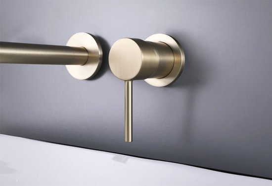 Gouden inbouwkraan met ronde hendel aan de muur.