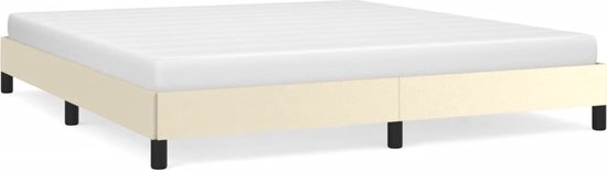 Crèmekleurig bedframe met matras en zwarte pootjes.