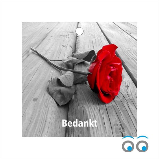 Une seule rose rouge sur fond de bois avec le mot 'Merci'.
