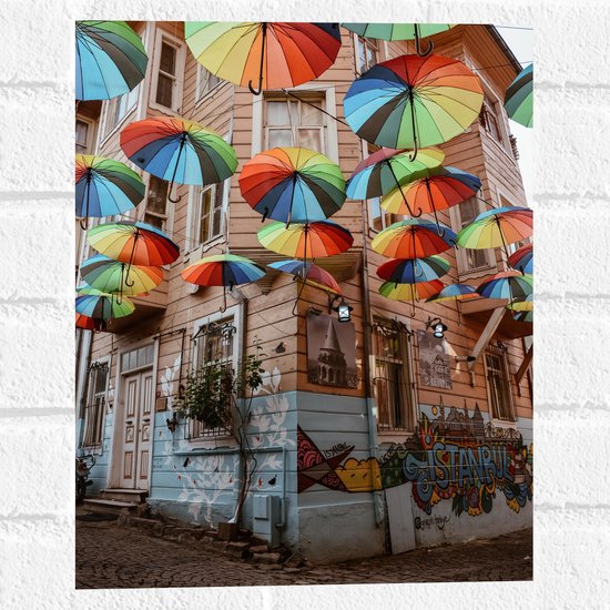 Muursticker - Plafond van Kleurrijke Paraplu's in Dorpssystraat - 30x40 cm Foto op Muursticker
