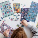 Plusieurs feuilles d'autocollants avec des images et des étoiles de Stitch sur une table blanche.