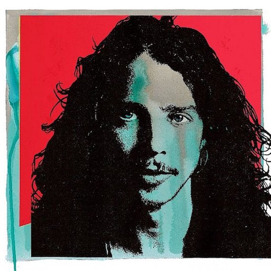 Portret van Chris Cornell met donker haar en een lichte baard op een rode achtergrond.