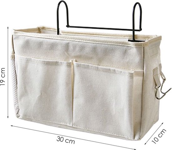 Witte stoffen bedorganizer met haken, met afmetingen 19 cm (hoog) x 30 cm (breed) x 10 cm (diep)..