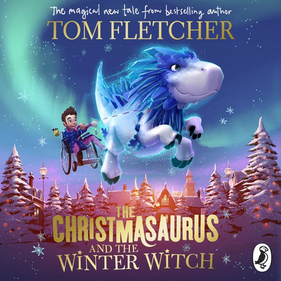 Een jongen in een rolstoel rijdt op een blauwe dinosaurus met kristallen manen voor een winterse kersttafereel. Tekst: "The Christmasaurus and the Winter Witch".