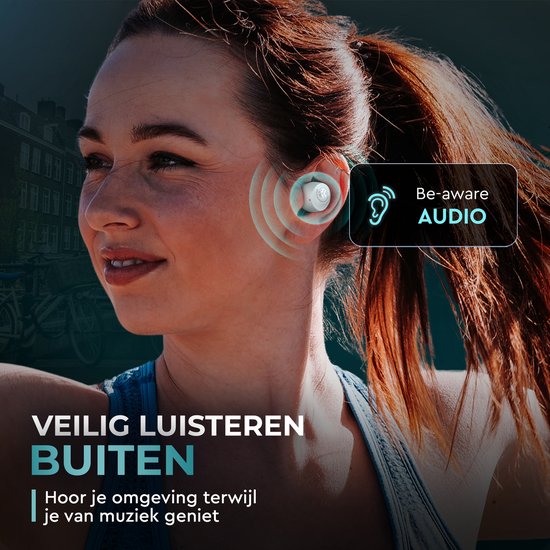Een lachende vrouw in een sportieve outfit, met een wit oordopje in haar oor. Be-aware AUDIO.