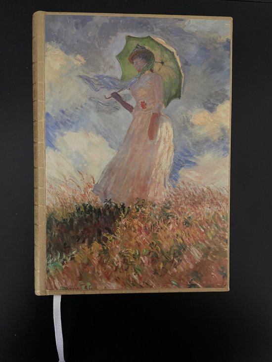 Notitieboek met op de omslag 'Vrouw met parasol' van Claude Monet. Een vrouw in een lichte jurk met een groene parasol.