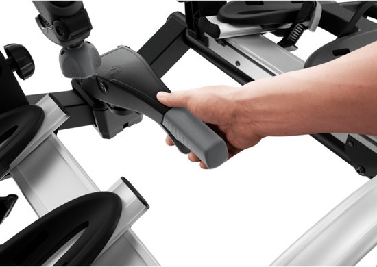 Hand die de hendel van de Thule fietsendrager bedient.