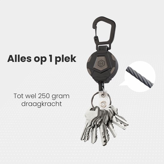 Porte-clés rétractable noir avec mousqueton et un trousseau de clés, avec une capacité de charge jusqu'à 250 grammes.