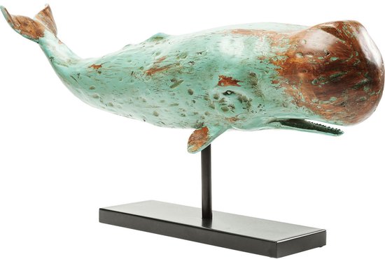 Houten beeld van een walvis, turquoise en bruin met verweerde details, op een zwarte standaard.