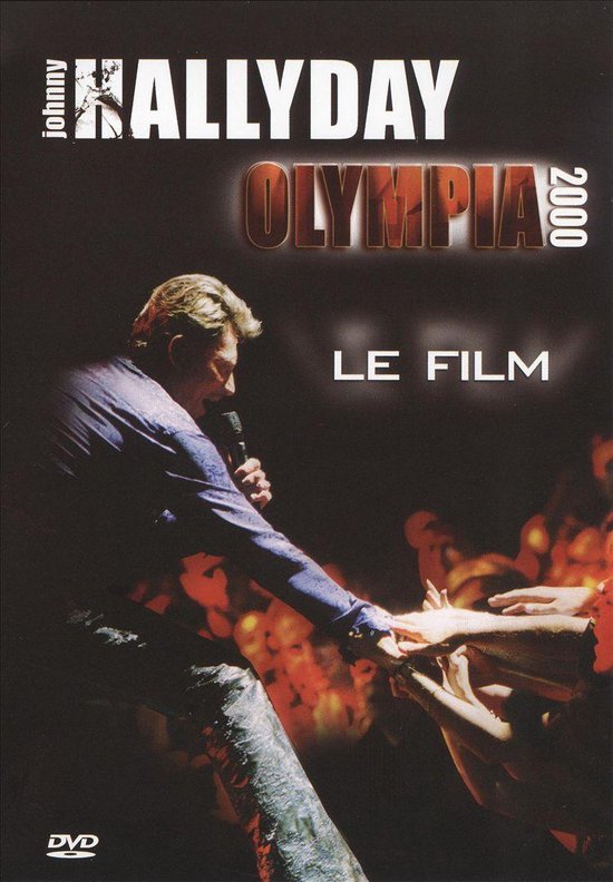 Johnny Hallyday Olympia 2000 concertfilm. Johnny in paars shirt en glitterbroek zingt op podium.