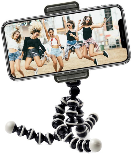 Smartphone met een foto van vijf springende vrouwen op een festival, gemonteerd op een flexibel zwart-wit statief.