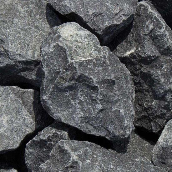 Grote, ruw gebroken breukstenen van donkergrijs basalt met lichtere aders.