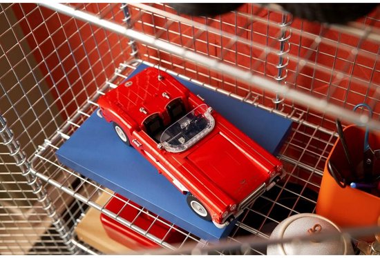 Rode LEGO Chevrolet Corvette cabriolet op een blauwe ondergrond in een metalen mand.