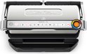 Bovenafgeziene Tefal contactgrill met gesloten deksel en een zwarte vetopvangbak. Het bedieningspaneel toont iconen en een kleurindicator.
