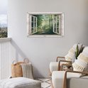 Poster van een bosweg met zonnestralen, in een open raam, boven twee fauteuils op een balkon.