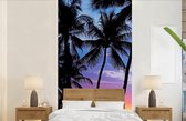 Behang - Fotobehang Een silhouet van palmbomen tijdens een zonsondergang op Hawaii - Breedte 120 cm x hoogte 240 cm