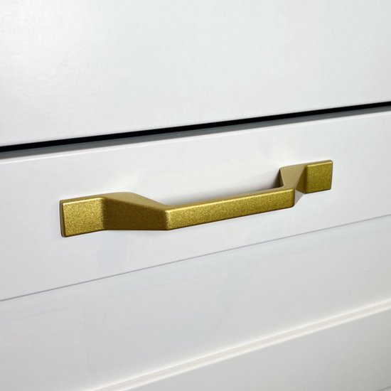 Gouden, hoekige meubelgreep op een witte lade.