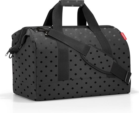 Zwarte weekendtas met handvatten, schouderband en een subtiel stippenpatroon.