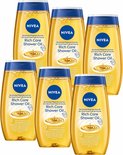 Zes flessen NIVEA Rich Care Shower Oil met blauwe dop. De gele flessen hebben tekst en een afbeelding van een druppel olie.