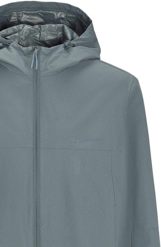 Close-up van een zilvergrijze jas met capuchon. De jas heeft een ritssluiting en een subtiel logo op de borst.