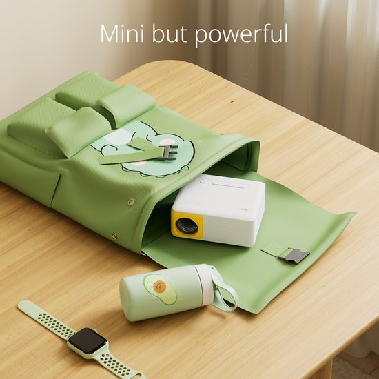 Een compacte witte en gele projector wordt uit een groene draagtas gehaald.