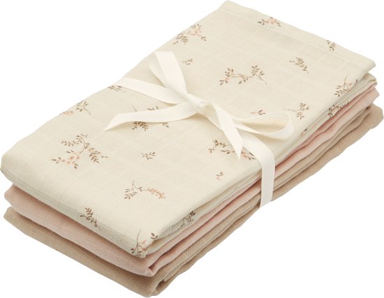 Set van drie hydrofiele doeken, gebonden met een crème lint. De bovenste doek heeft een zacht bloemenpatroon.