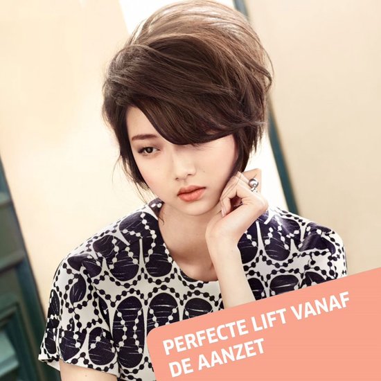 Vrouw met volumineus bruin kapsel, draagt zwart wit shirt. "Perfecte lift vanaf de aanzet".