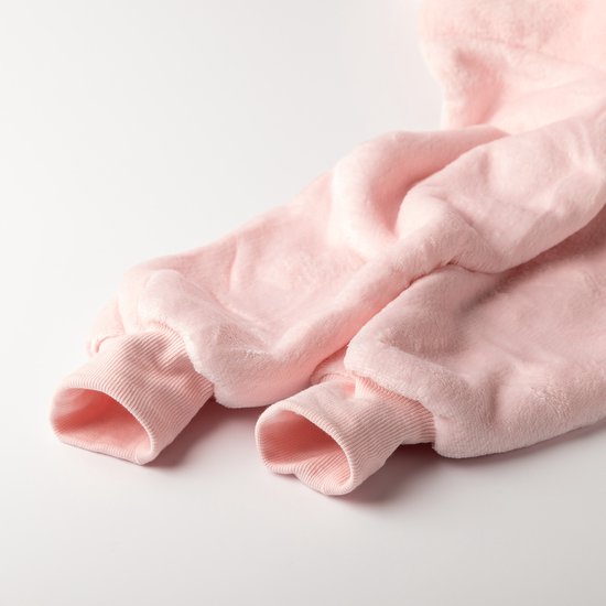 Close-up van de mouwen van een roze, oversized hoodie deken.