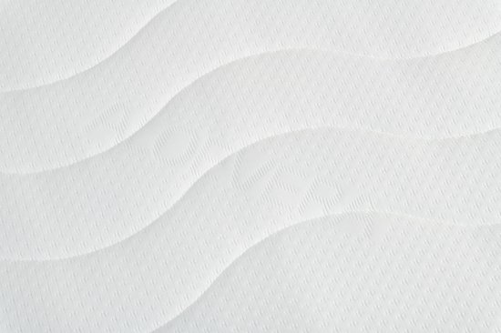 Witte matras met golvend stikselpatroon.