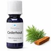 Donkerblauwe fles met witte dop 'Slaaploos Cederhout 100% Etherische olie 10ml'. Naast de fles liggen cederhout takjes.