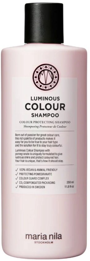 Lichtroze fles met zwarte dop, met het "Luminous Colour Shampoo" logo en productdetails, op een witte achtergrond.