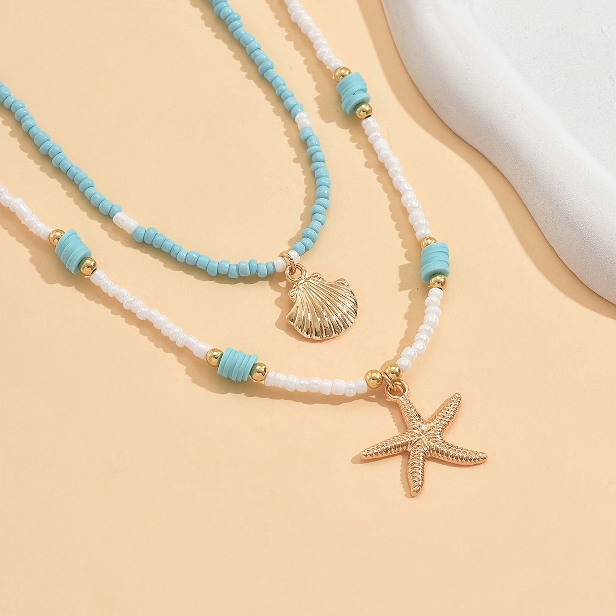 Sjika - Bohemian Strand Ketting Dames – 2 Delige Kralen Ketting Set met Zeester & Schelp Hanger – Zomer Choker Kettingen Wit Blauw Goud - Cadeau voor haar
