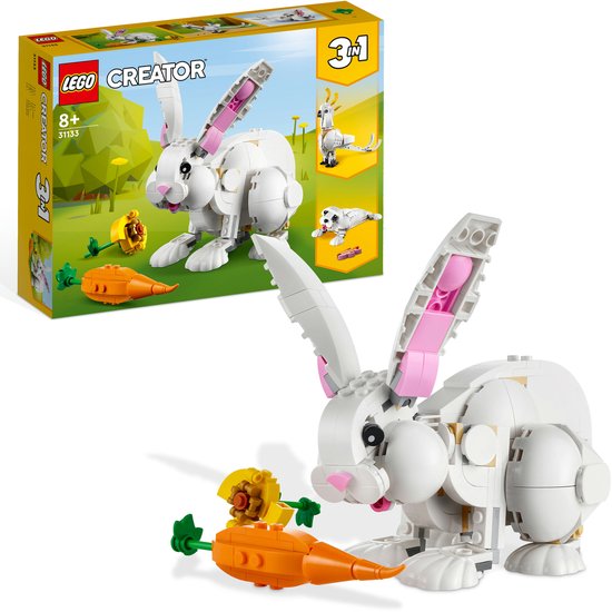 Un lapin LEGO blanc avec de longues oreilles et une carotte.