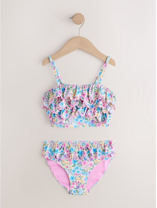Wit bikini met bloemenprint in roze, blauw en geel, met ruches aan de top en broekje.