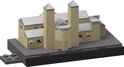 Kleine bouw met beige muren, grijze daken en twee torens, op een zwarte basis.