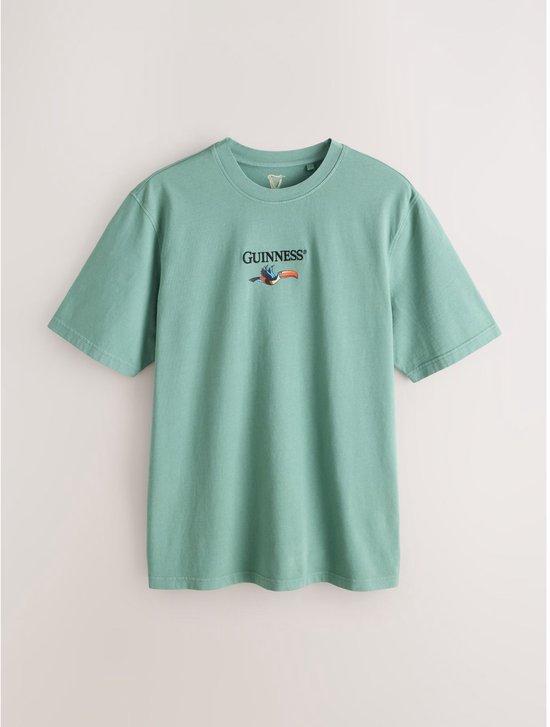 Turquoise t-shirt met opdruk van een toekan en het logo van Guinness op de borst.