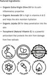 Afbeelding toont 'Featured Ingredients' van Dadi'Oil: olijfolie, avocadoolie, jojobaolie en vitamine E. Bevat ook keurmerken zoals 'Cruelty Free' en 'Vegan'.