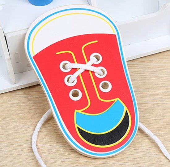 Rood houten speelschoentje met blauwe en zwarte patronen, gedeeltelijk geregen met witte veters.