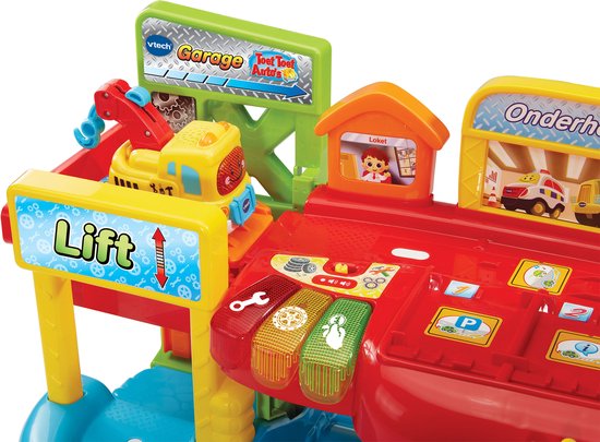 Close-up van VTech Toet Toet Auto's speelgoedgarage met 'Lift' bord, auto-onderdelen en kleurrijke knoppen.