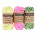 Drie bollen Scheepjes Catona garen in geel, roze en groen.