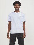 Wit T-shirt met korte mouwen en een klein zwart logo op de borst, gedragen door een man, van voren gezien.