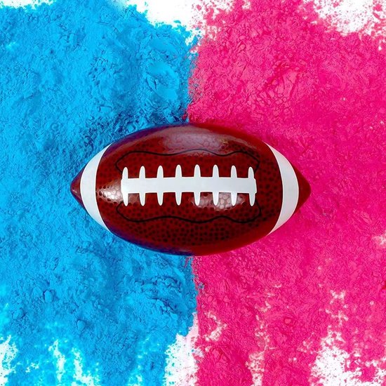 Un ballon de rugby au centre avec de la poudre rose d'un côté et de la poudre bleue de l'autre.