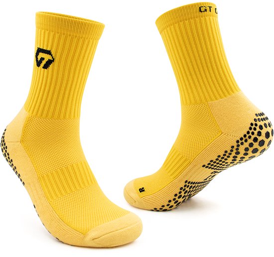 Chaussettes de sport jaunes avec crampons noirs sur la semelle et le talon, logo GT GRIP.