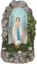 Beeld Maria van Lourdes in  grot met verlichting.