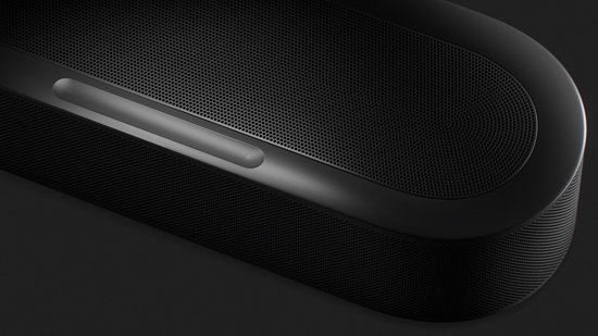 Zwarte Sonos soundbar met volumeknoppen (+ en -) bovenop en een geperforeerd rooster.