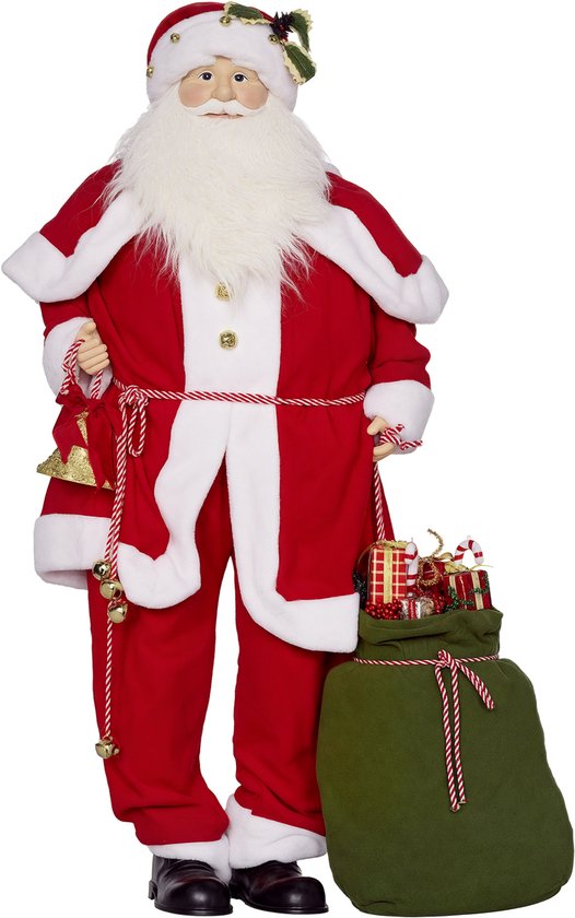 Figurine Père Noël debout avec vêtements rouges, bordures blanches en fourrure, clochette et sac cadeau vert avec cadeaux.