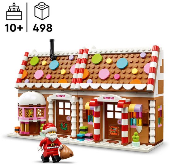 Een LEGO peperkoekhuis met kerstman, met een façades met snoepstokken, roze accenten en veelkleurige raampjes. Er staat "9083" op het postkantoor.